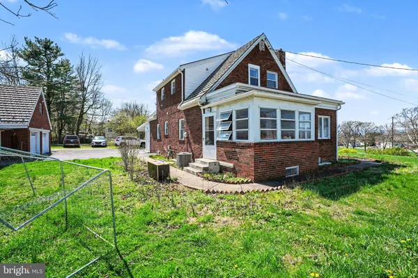 a front view of a house with a yard table and chairs