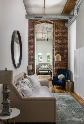 a living room with furniture and a mirror