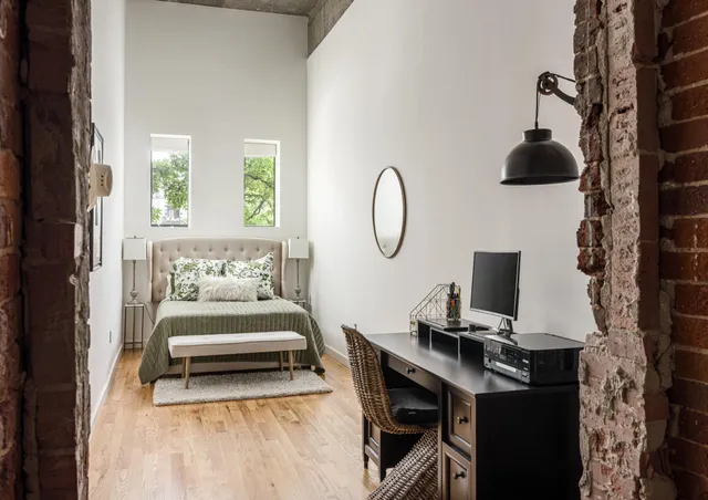 a living room with furniture a flat screen tv and a window
