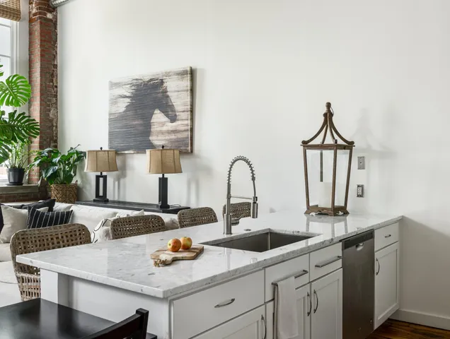 a kitchen with appliances a sink and cabinets