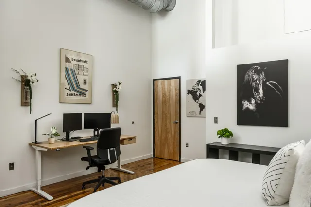 a bedroom with a workspace