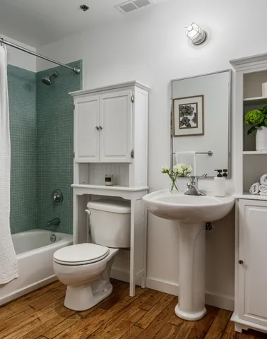 a bathroom with a sink toilet and shower