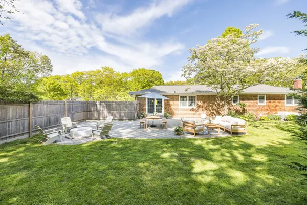 a front view of a house with garden and patio