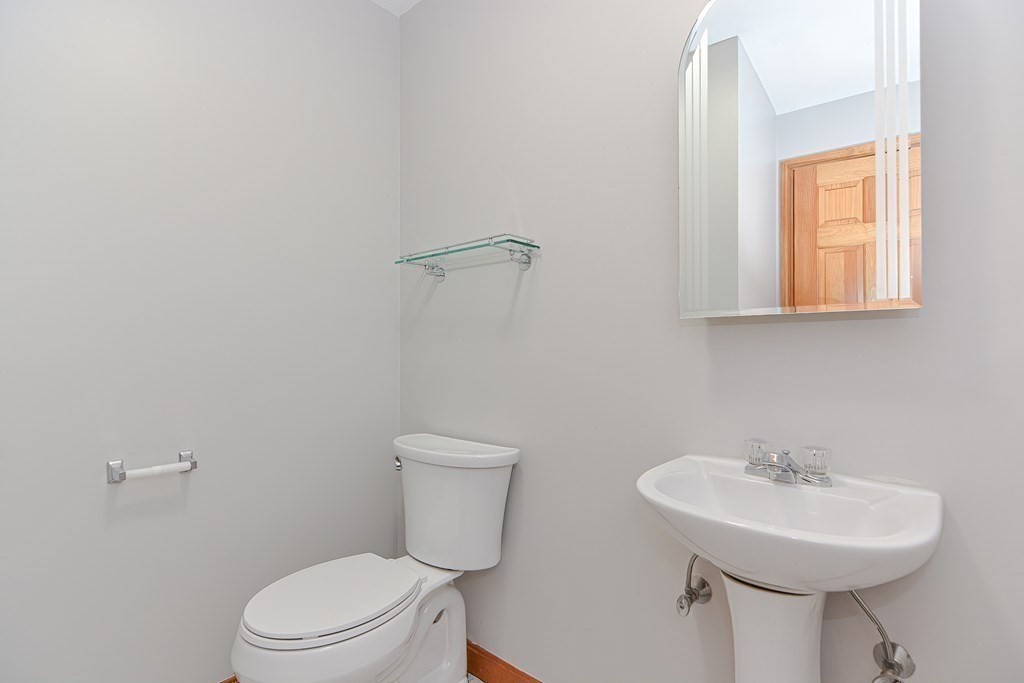 4 Bugli Lane Wakefield, MA 01880 - Photo 13 of 32 a white toilet sitting next to a bathroom sink