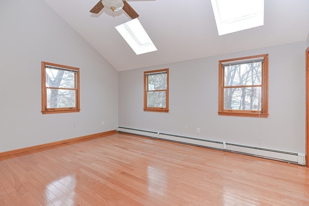 4 Bugli Lane Wakefield, MA 01880 - Photo 18 of 32 a view of an empty room with wooden floor and a window