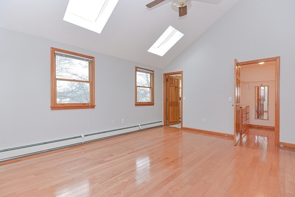 4 Bugli Lane Wakefield, MA 01880 - Photo 19 of 32 a view of an empty room with window and wooden floor