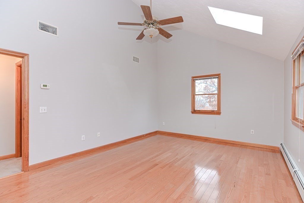 4 Bugli Lane Wakefield, MA 01880 - Photo 20 of 32 an empty room with a window and a fan
