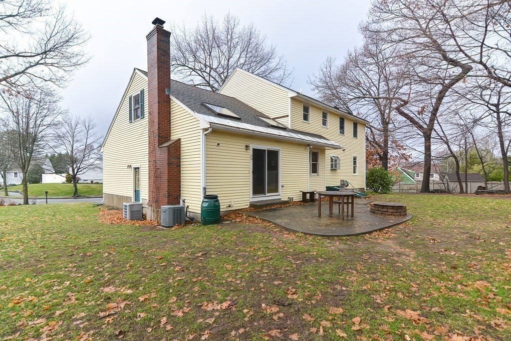 4 Bugli Lane Wakefield, MA 01880 - Photo 30 of 32 a view of a house with backyard and trees