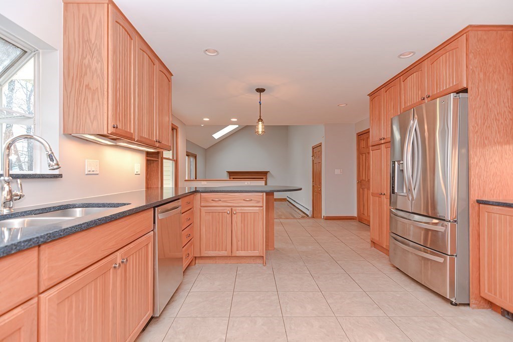 4 Bugli Lane Wakefield, MA 01880 - Photo 7 of 32 a kitchen with stainless steel appliances granite countertop a refrigerator and a sink