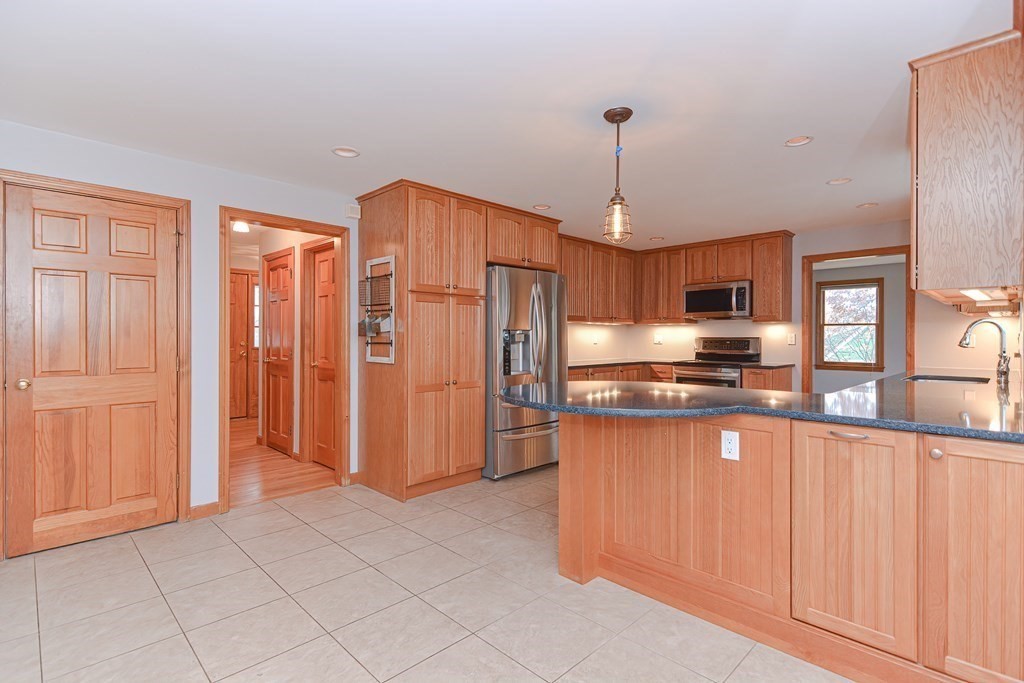 4 Bugli Lane Wakefield, MA 01880 - Photo 8 of 32 a open kitchen with stainless steel appliances granite countertop a refrigerator and microwave