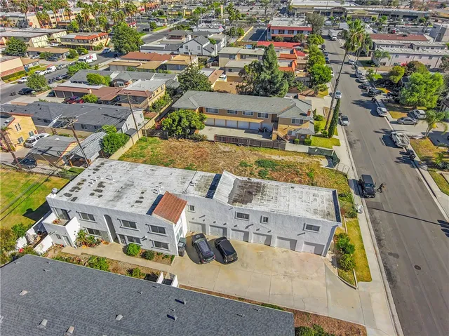 an aerial view of residential houses with outdoor space