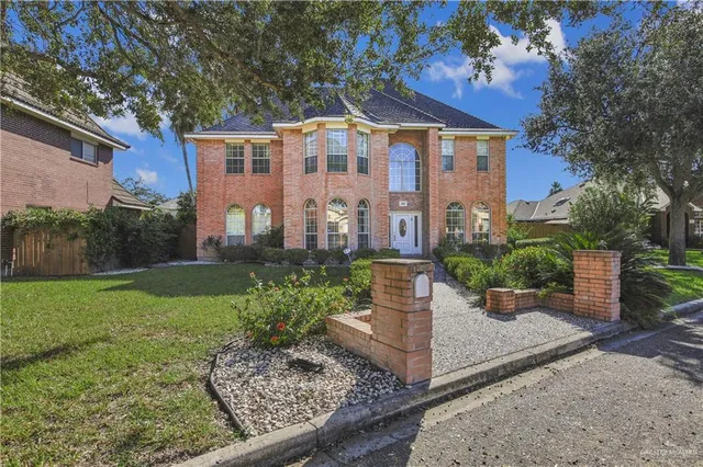 a front view of a house with a garden