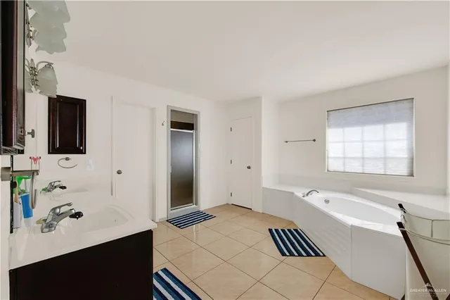 a spacious bathroom with a bathtub and a sink