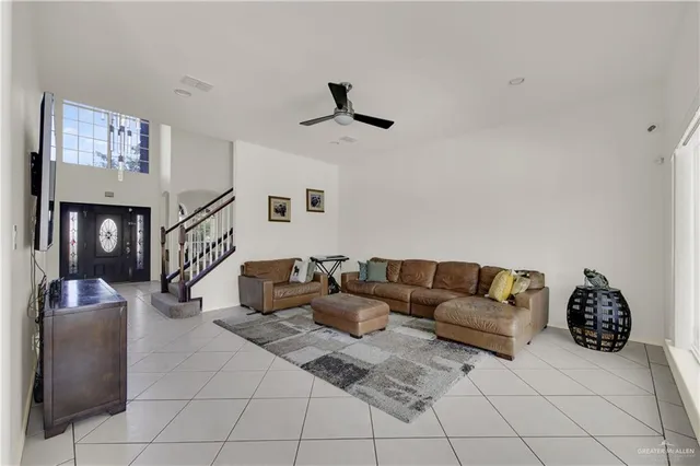 a living room with furniture and a ceiling fan
