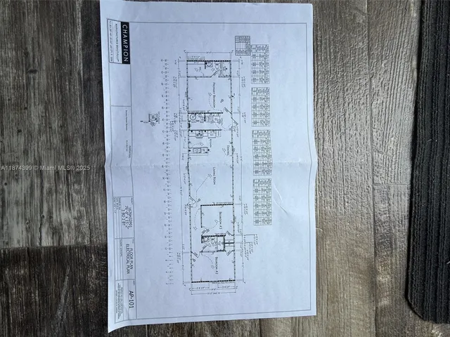 a kitchen with granite countertop white cabinets and refrigerator