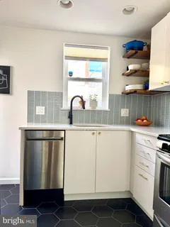 a kitchen with white cabinets and white appliances