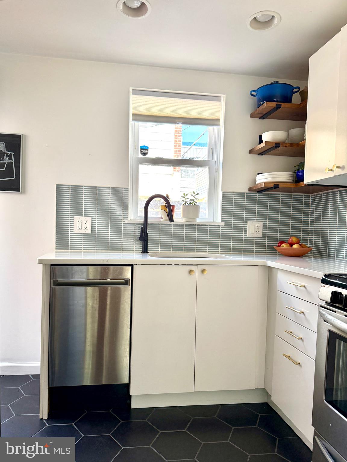 1509 Emily Street Philadelphia, PA 19145 - Photo 12 of 33 a kitchen with white cabinets and white appliances