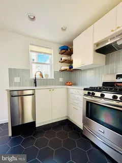 a kitchen with a white stove top oven and sink