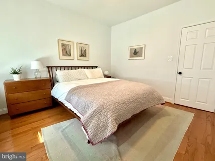 a bedroom with a bed and a night stand