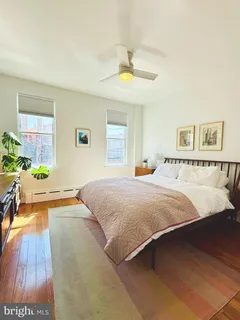 a spacious bedroom with a bed and a chandelier
