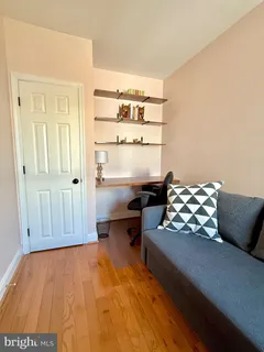 a living room with furniture rug and wooden floor