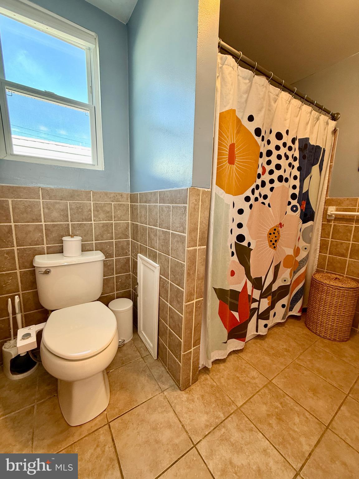 1509 Emily Street Philadelphia, PA 19145 - Photo 25 of 33 a bathroom with a toilet and a shower curtain