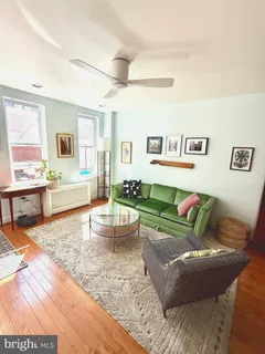 a living room with furniture and a rug