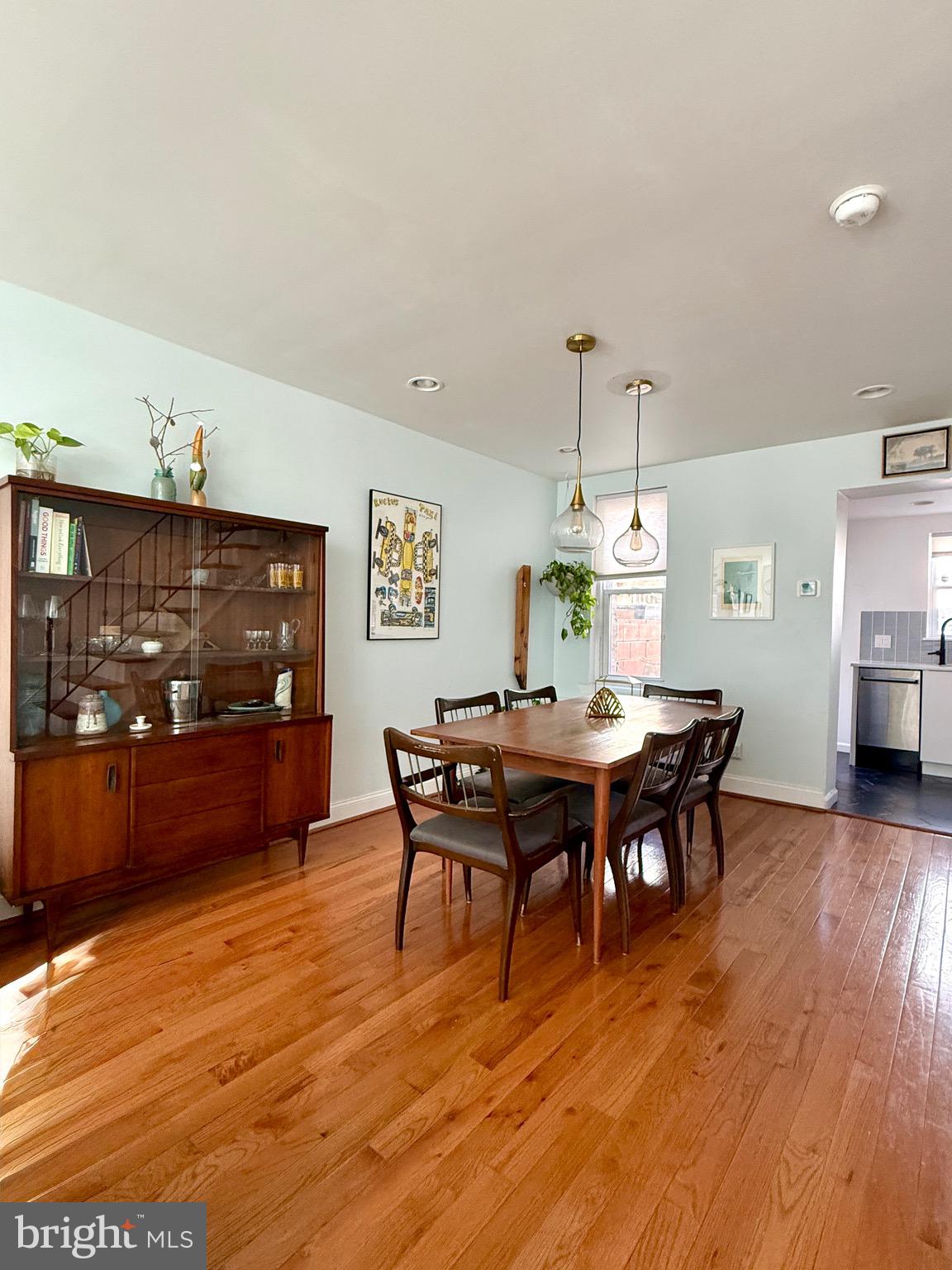 1509 Emily Street Philadelphia, PA 19145 - Photo 7 of 33 a dining room with wooden floor a chandelier a wooden table and chairs