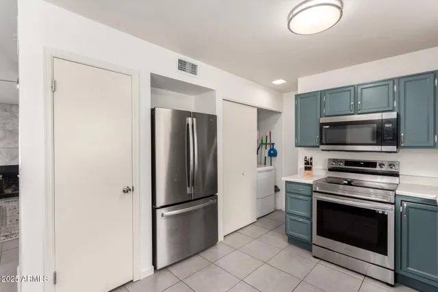 a kitchen with stainless steel appliances a refrigerator stove and microwave