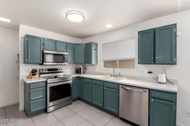 a kitchen with a sink stove and microwave