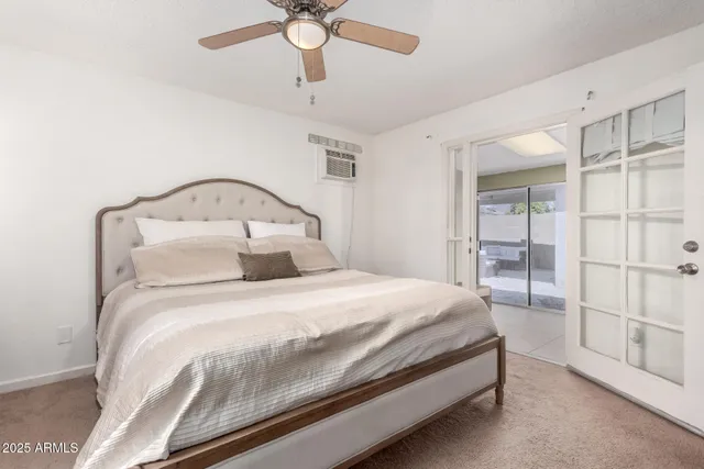 a bedroom with a bed and a ceiling fan