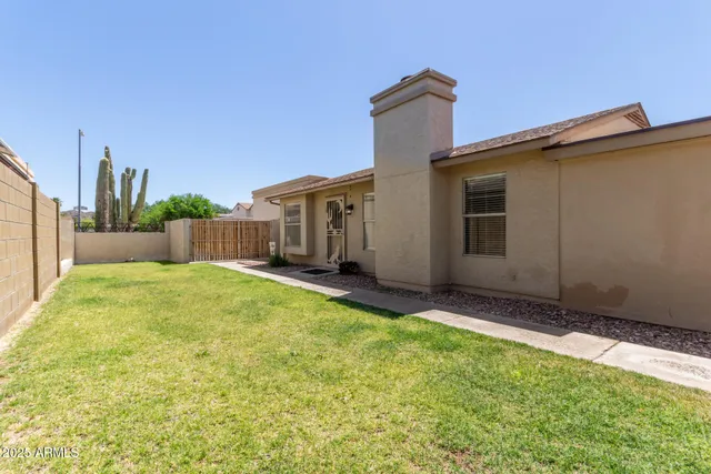 a view of a back yard with patio