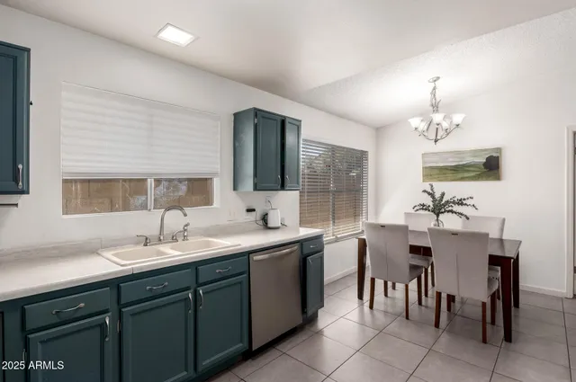 a kitchen with a sink dining table and chairs