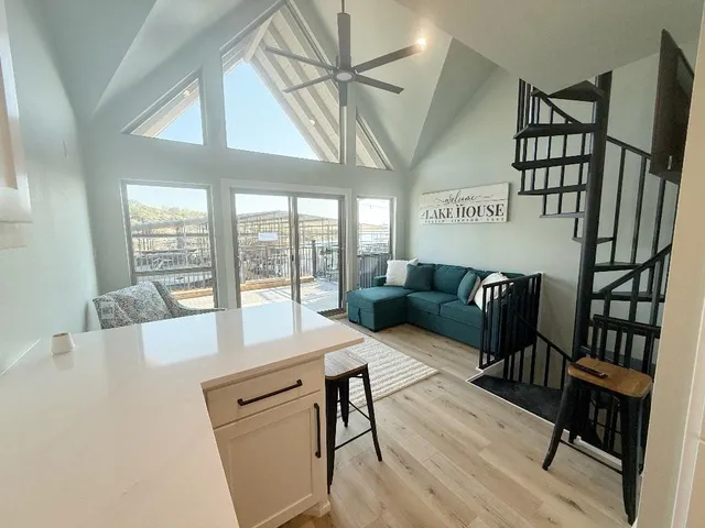 a living room with furniture a large window with wooden floor