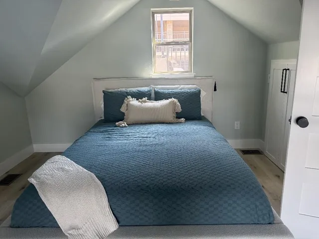 a bedroom with a bed and window
