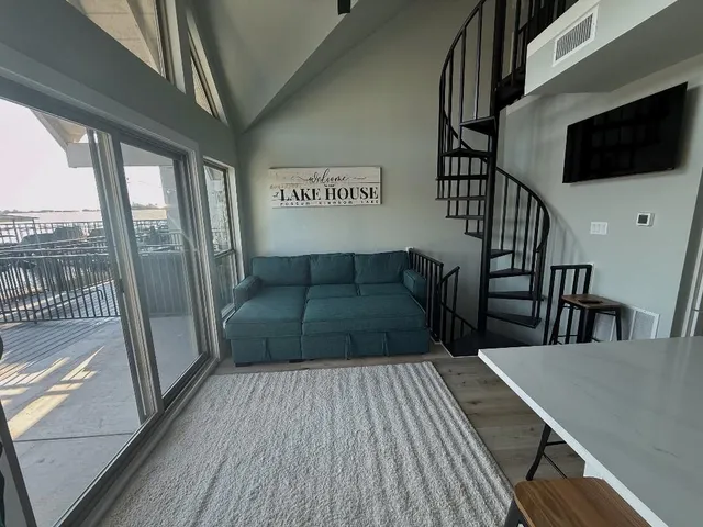 a view of a livingroom with wooden floor and furniture