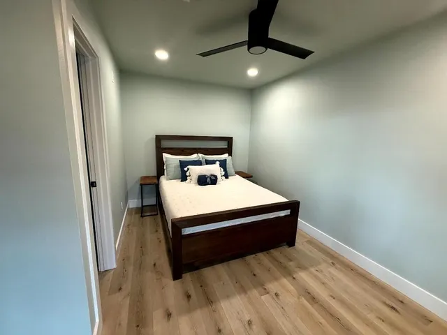 a bedroom with a bed and a ceiling fan