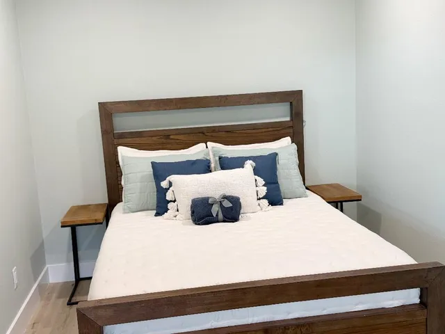 a bed sitting in a bedroom next to a wall