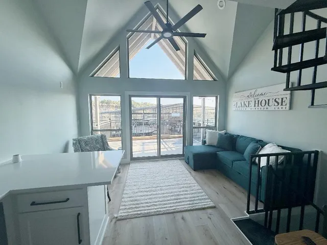 a living room with furniture and a floor to ceiling window
