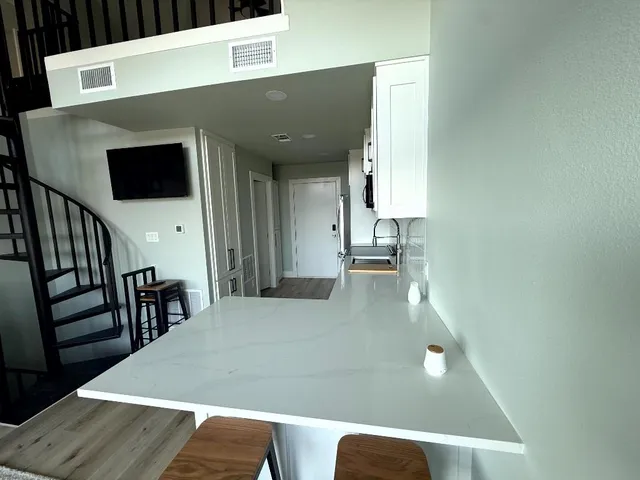 a view of kitchen and dining room with wooden floor