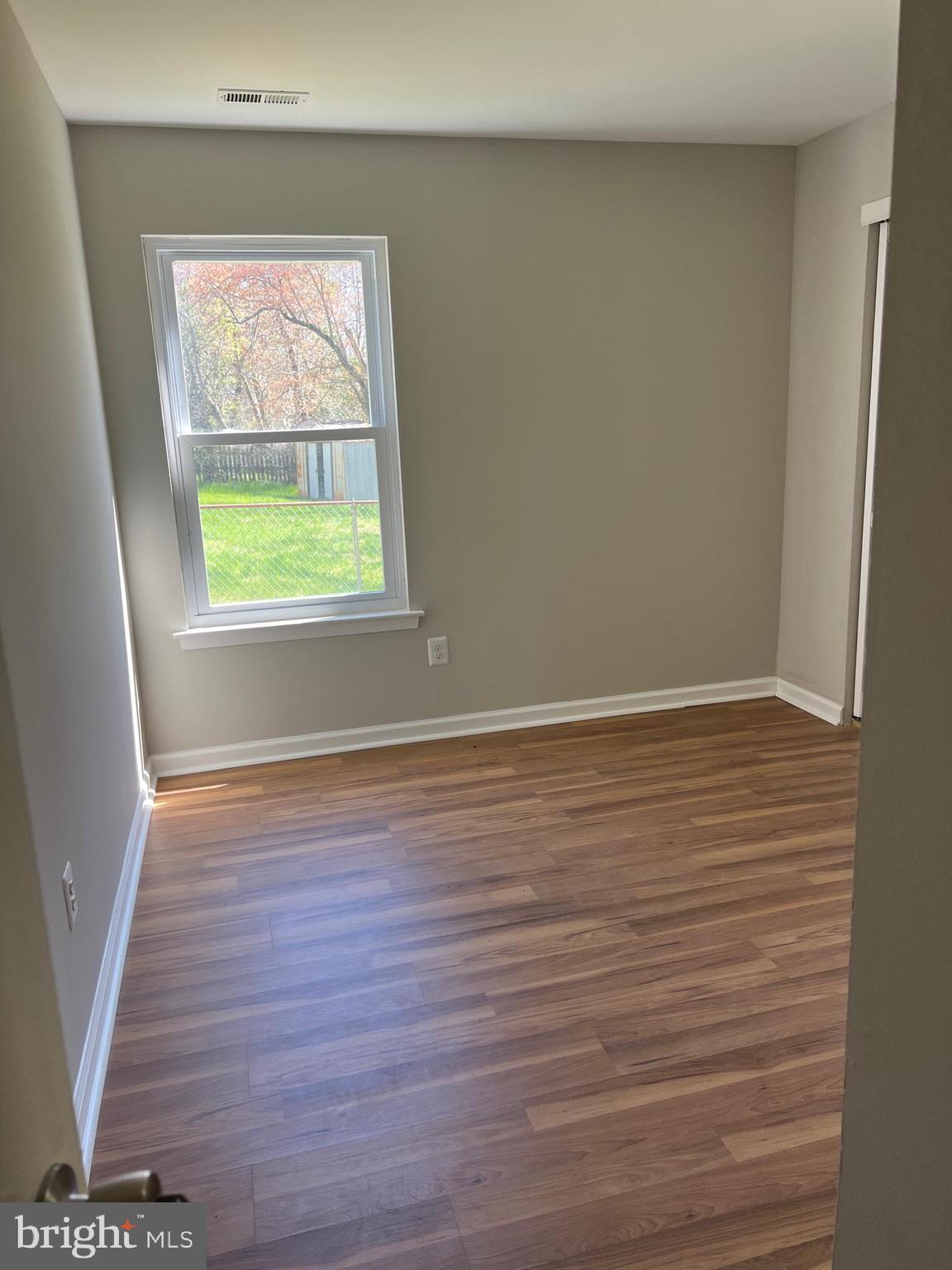 16 Maynard Drive, Unit A Sicklerville, NJ 08081 - Photo 11 of 17 an empty room with wooden floor and windows