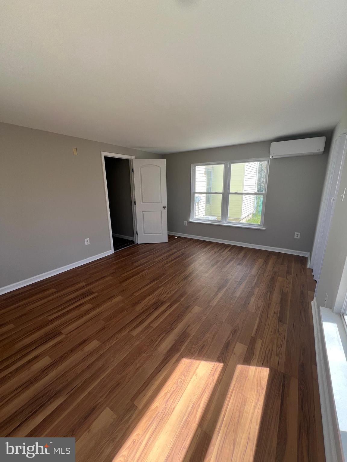 16 Maynard Drive, Unit A Sicklerville, NJ 08081 - Photo 15 of 17 wooden floor in an empty room with a window
