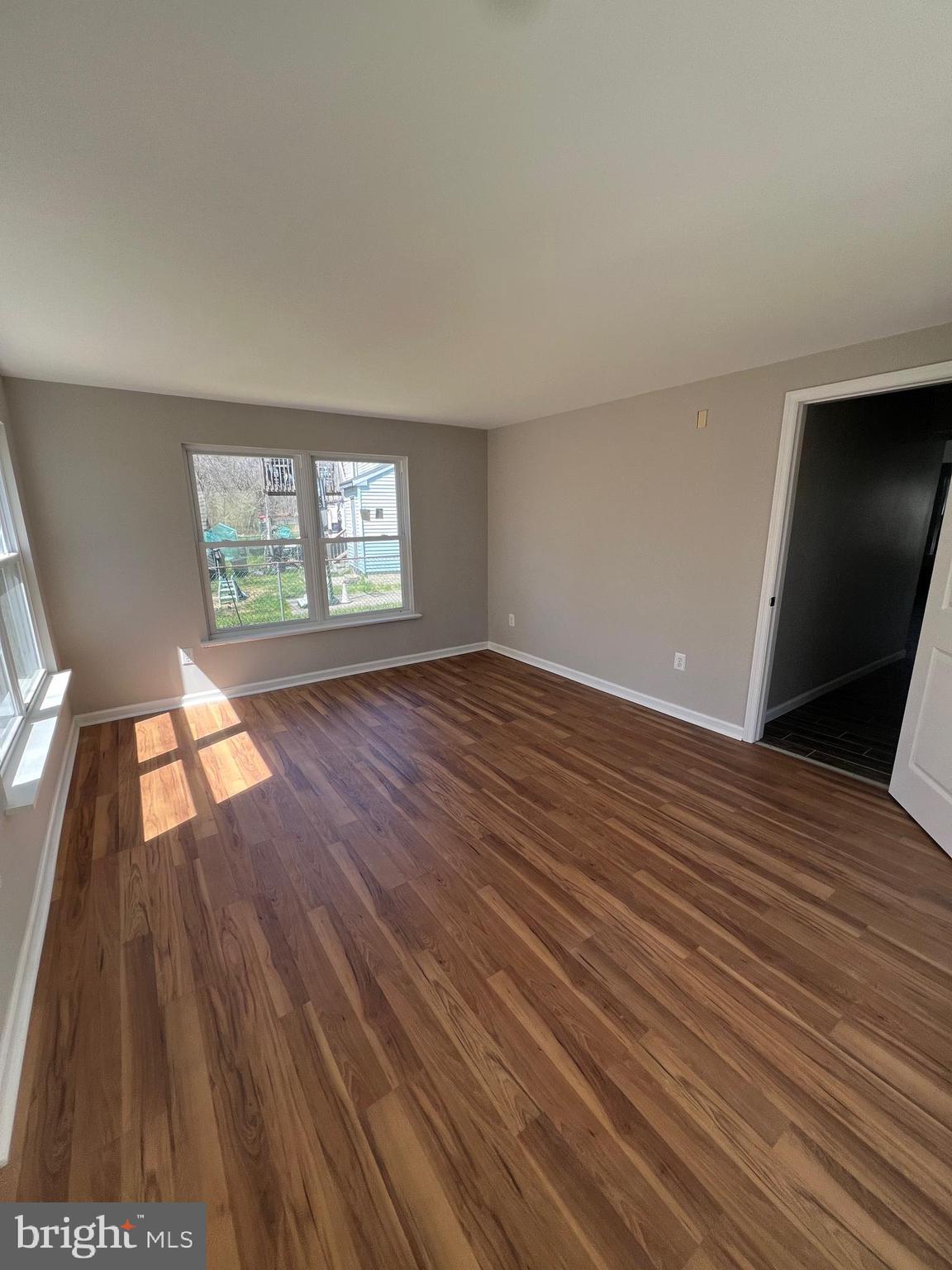 16 Maynard Drive, Unit A Sicklerville, NJ 08081 - Photo 16 of 17 an empty room with wooden floor and windows