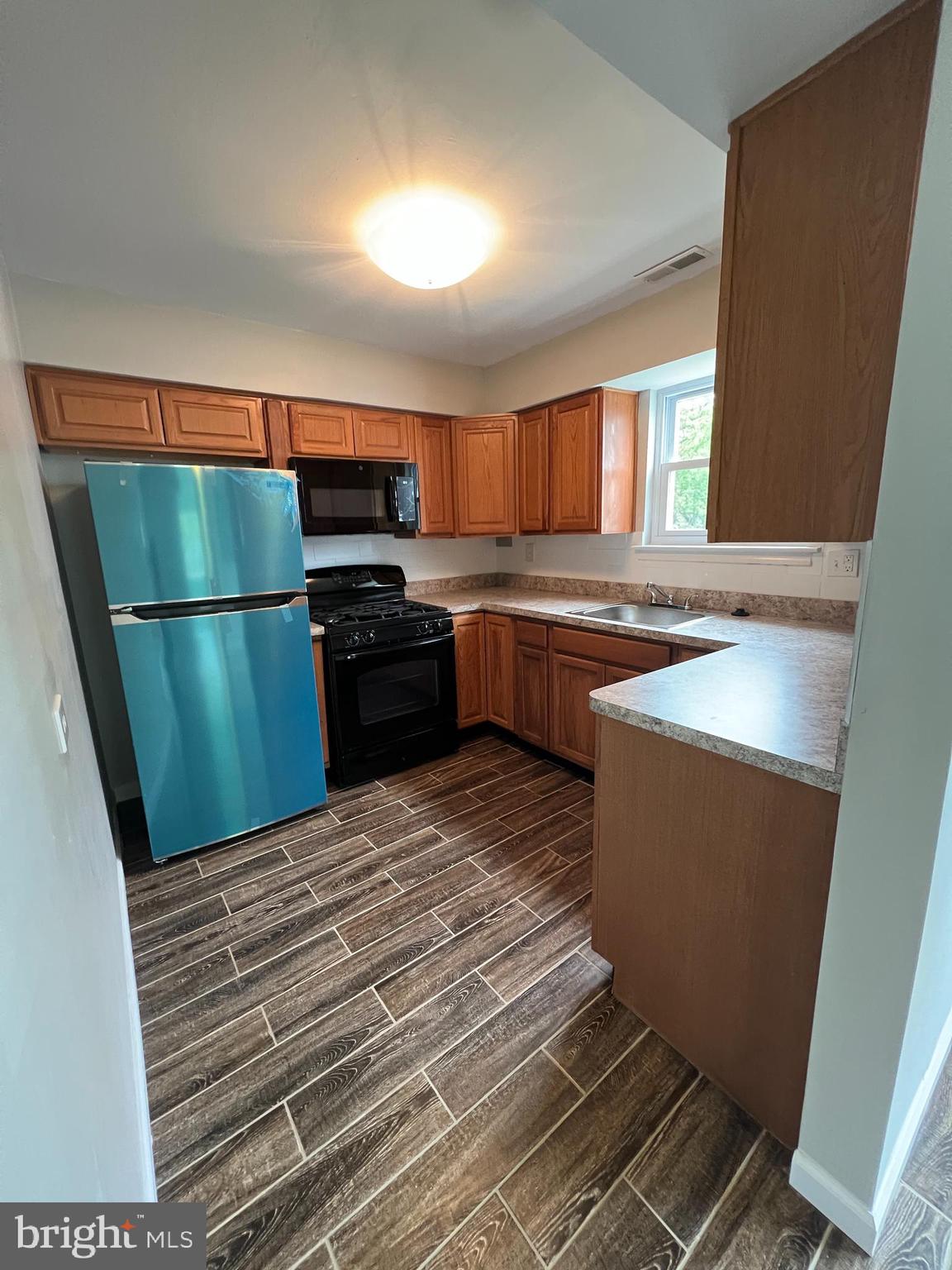 16 Maynard Drive, Unit A Sicklerville, NJ 08081 - Photo 5 of 17 a kitchen with a refrigerator and a stove top oven