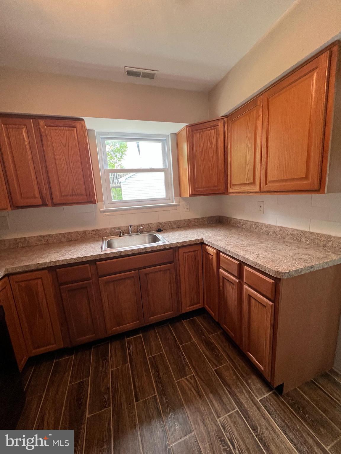 16 Maynard Drive, Unit A Sicklerville, NJ 08081 - Photo 6 of 17 a kitchen with granite countertop wooden cabinets a sink and a stove