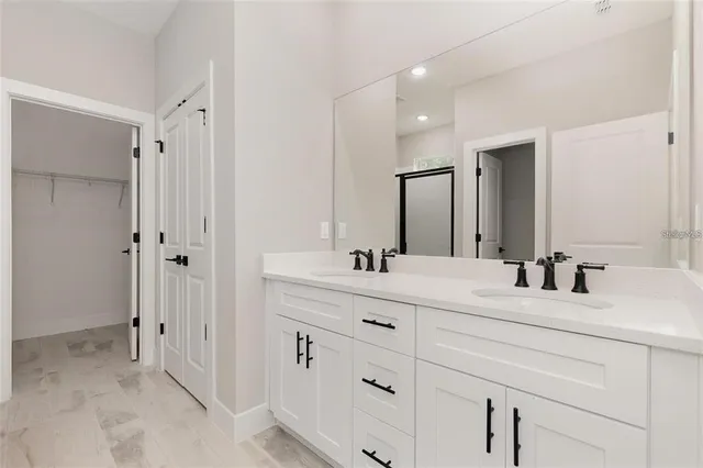 a bathroom with a double vanity sink mirror and double