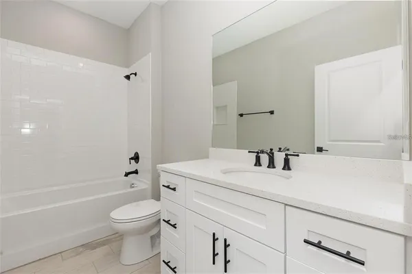 a bathroom with a sink a toilet and a bathtub