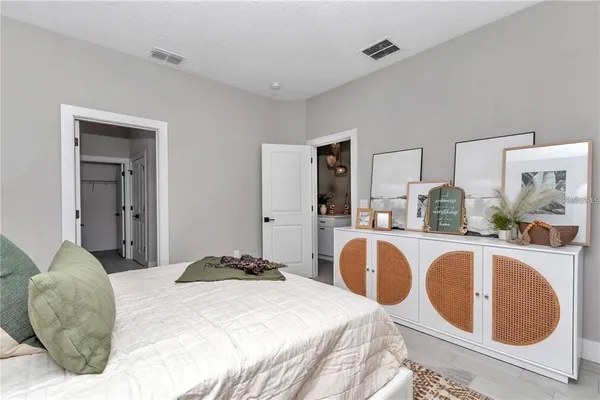 a bedroom with a bed and lamp