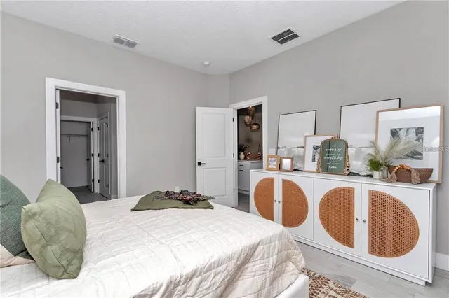 a bedroom with a bed and lamp