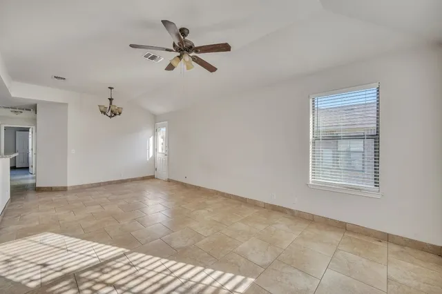 a view of a livingroom with a ceiling fan and window